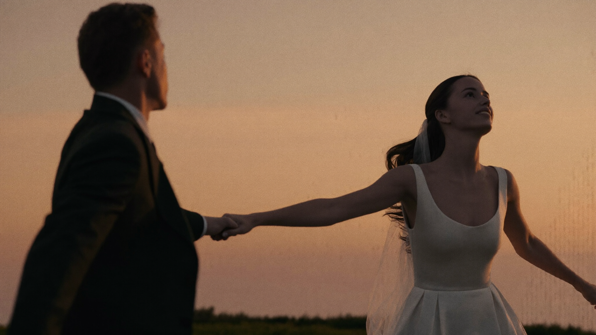A newlywed couple sharing their first dance in warm light